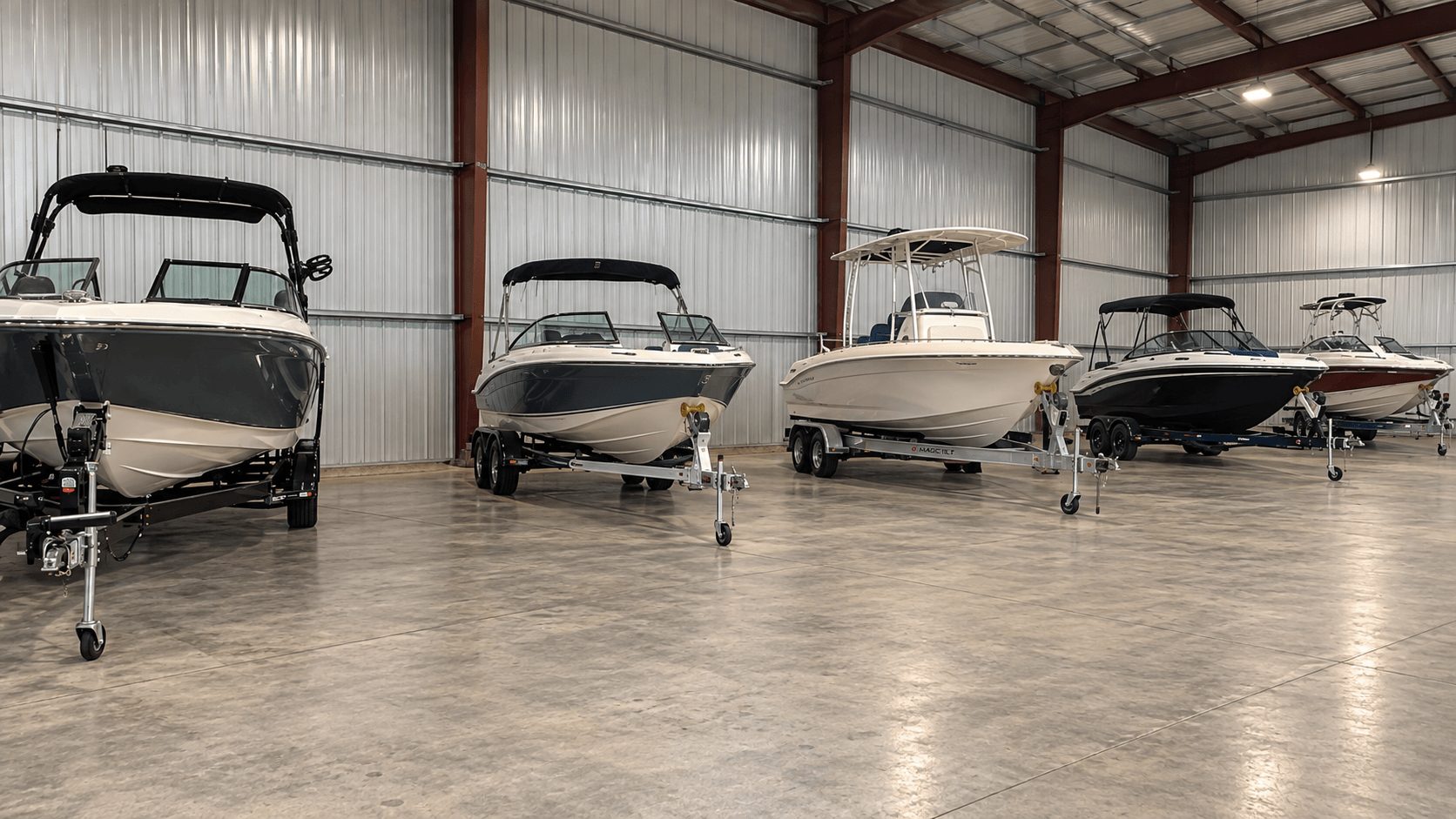 Ski boats and fishing boats on their trailers parked inside the heated Jenson Storage building in Logan, Utah