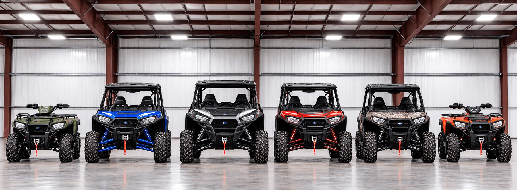 A row of UTVs and side-by-sides parked inside the heated Jenson Storage building in Logan, Utah